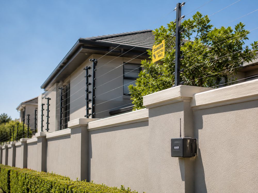 Electric fence installation on a boundary wall